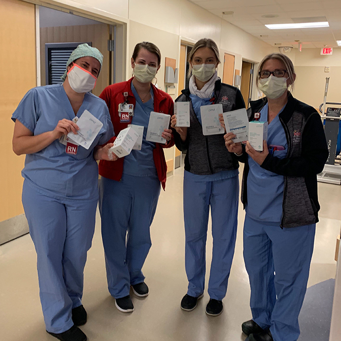 4 healthcare workers holding PMD products